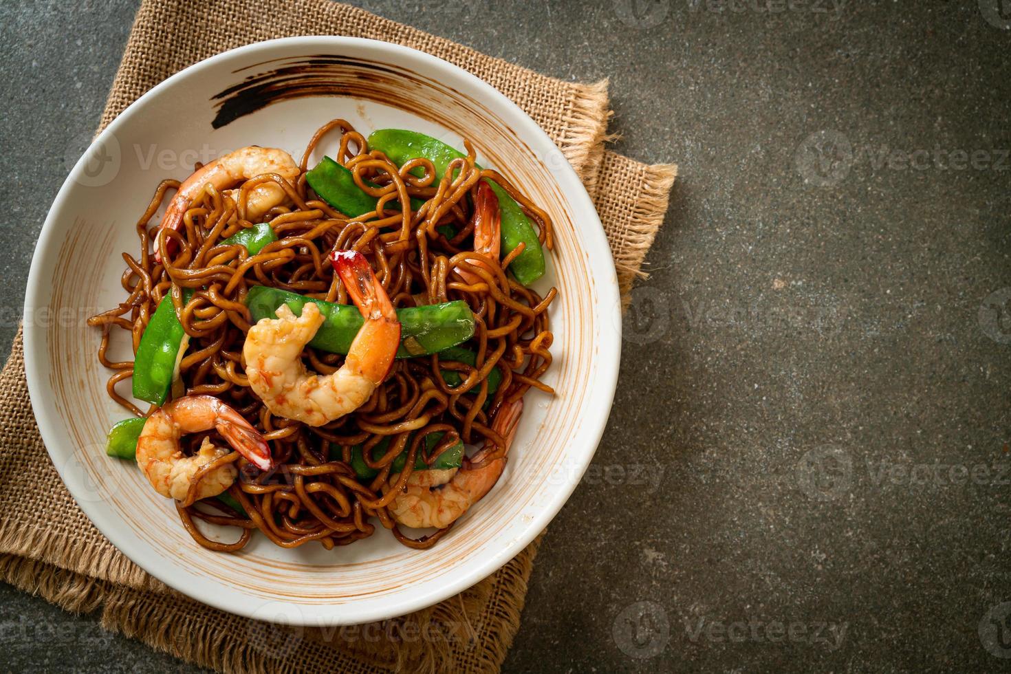 Stir-fried yakisoba noodles with green peas and shrimps - Asian food style photo