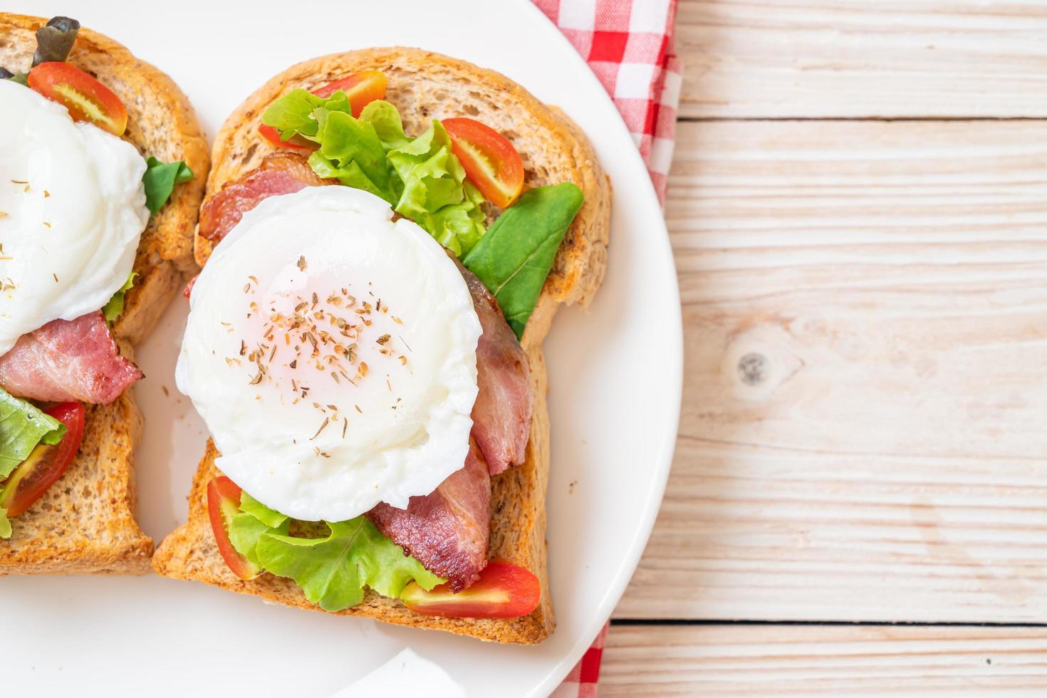 Whole wheat bread toasted with vegetable, bacon, and egg or egg benedict, for breakfast photo