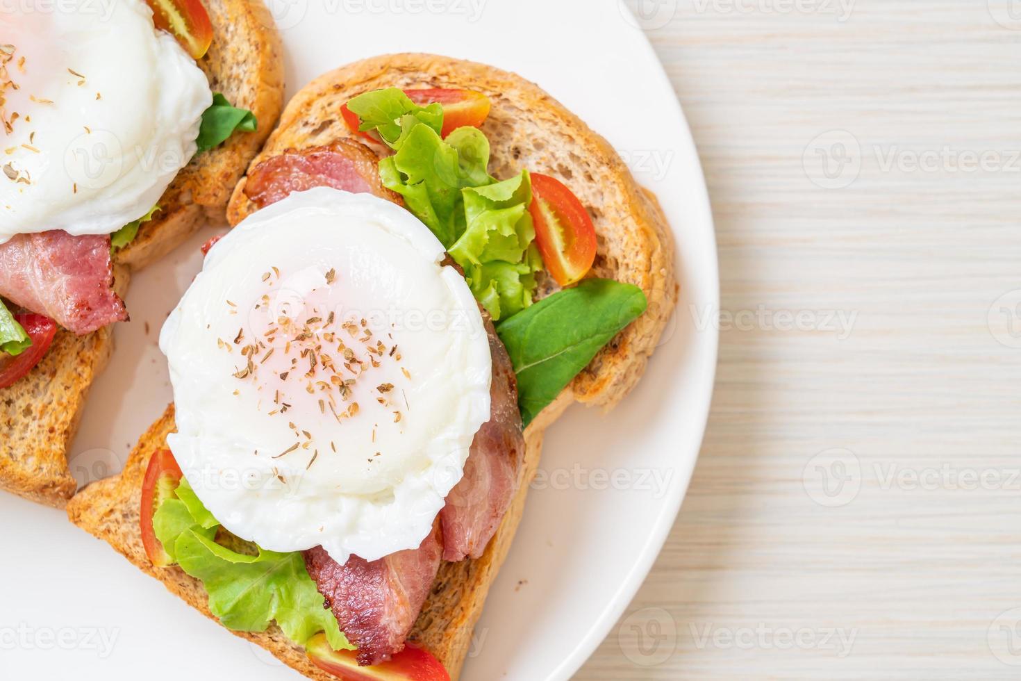Whole wheat bread toasted with vegetable, bacon, and egg or egg benedict, for breakfast photo