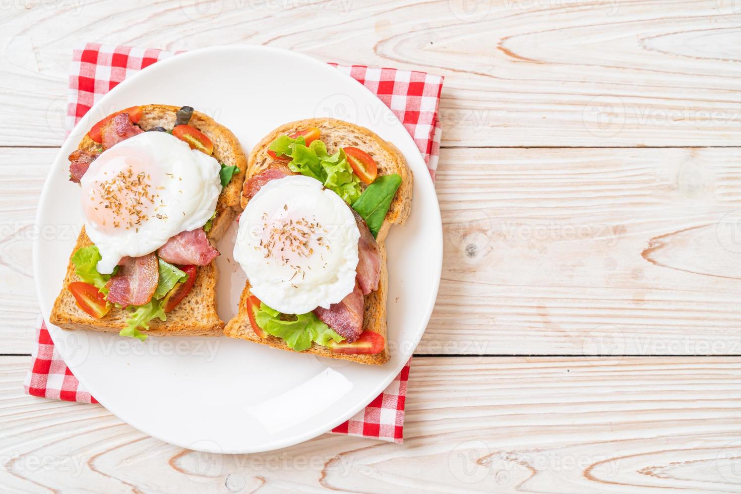 Whole wheat bread toasted with vegetable, bacon, and egg or egg benedict, for breakfast photo