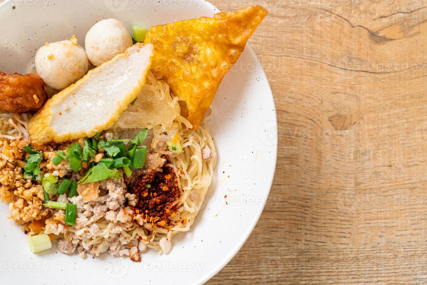 Spicy noodles with fish ball and minced pork or Tom Yum Noodles - Asian food style photo