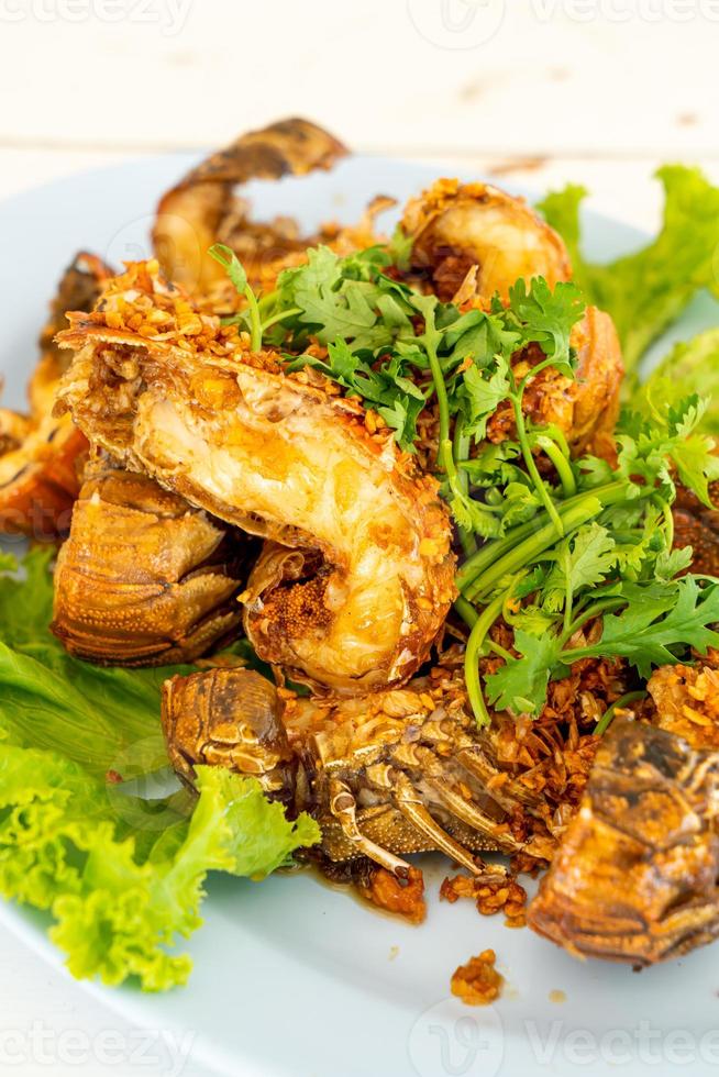 Fried crayfish or mantis shrimps with garlic - seafood style photo