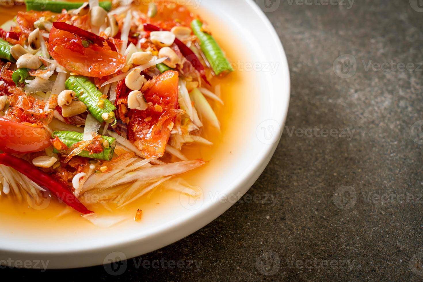 Papaya spicy salad - somtam - Thai traditional street food style photo