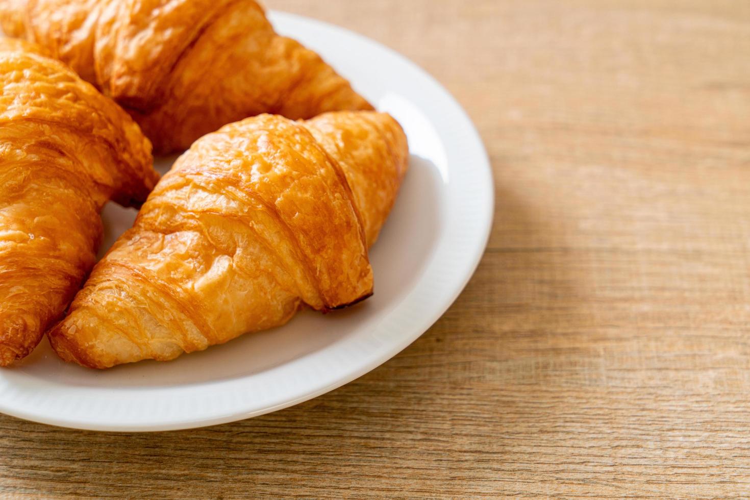 Fresh butter croissant on plate photo