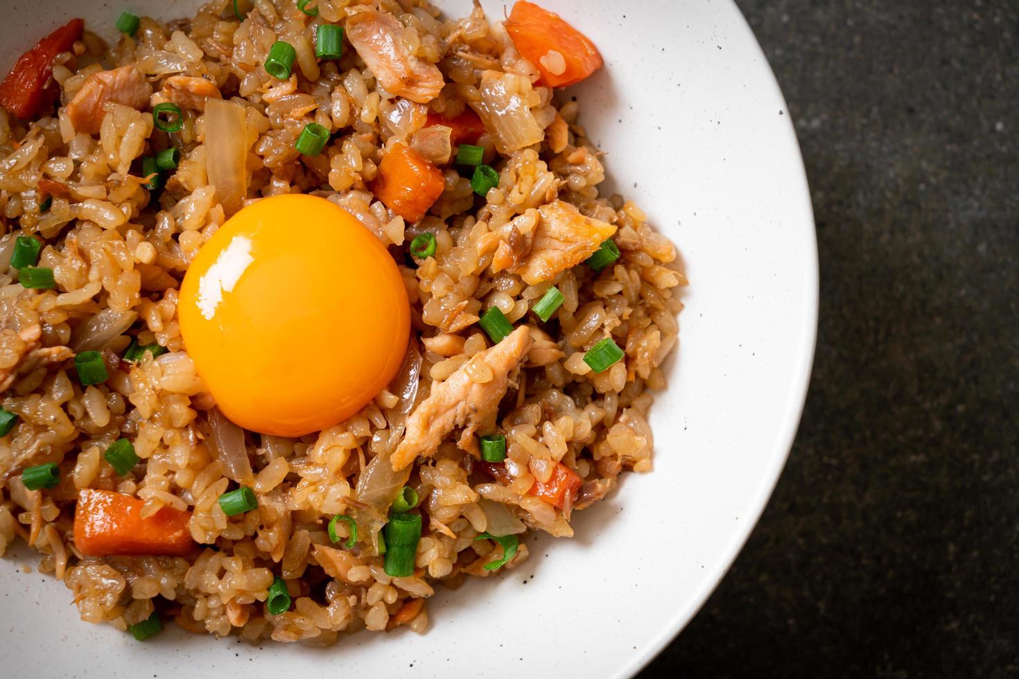 Salmon fried rice with pickled egg on top - Asian food style photo