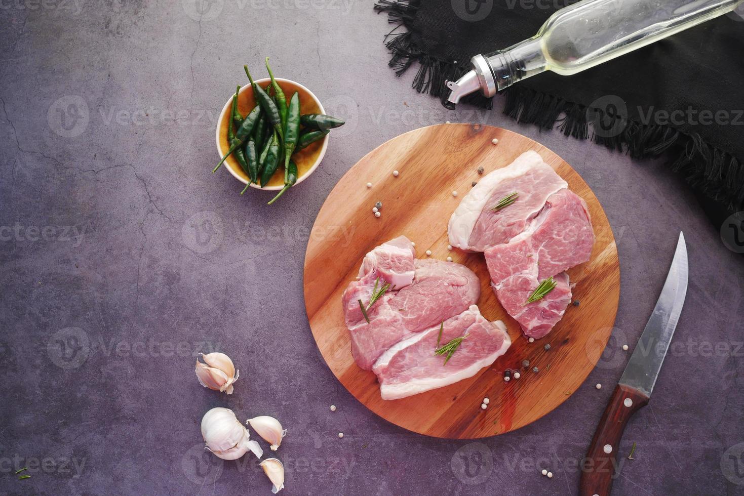 Top view of raw meat on chopping board on black background photo