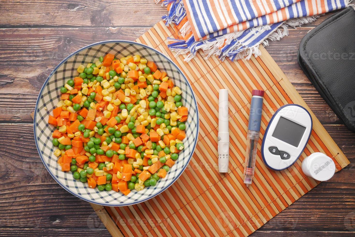 Diabetic measurement tools and healthy food on table photo