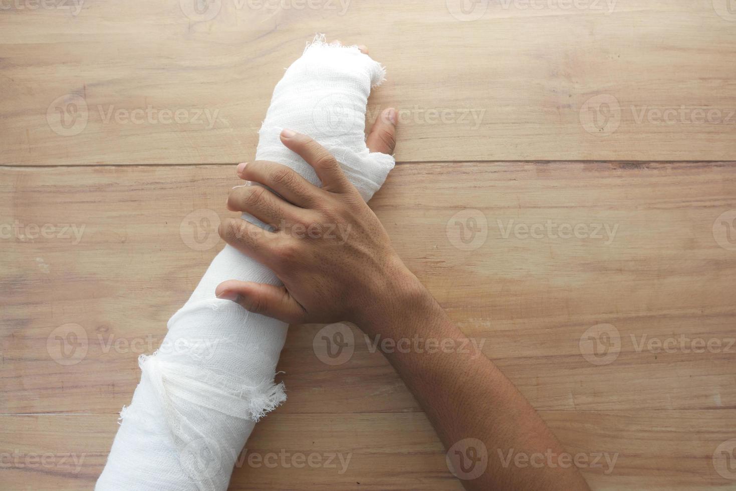 Injured painful hand with bandage photo