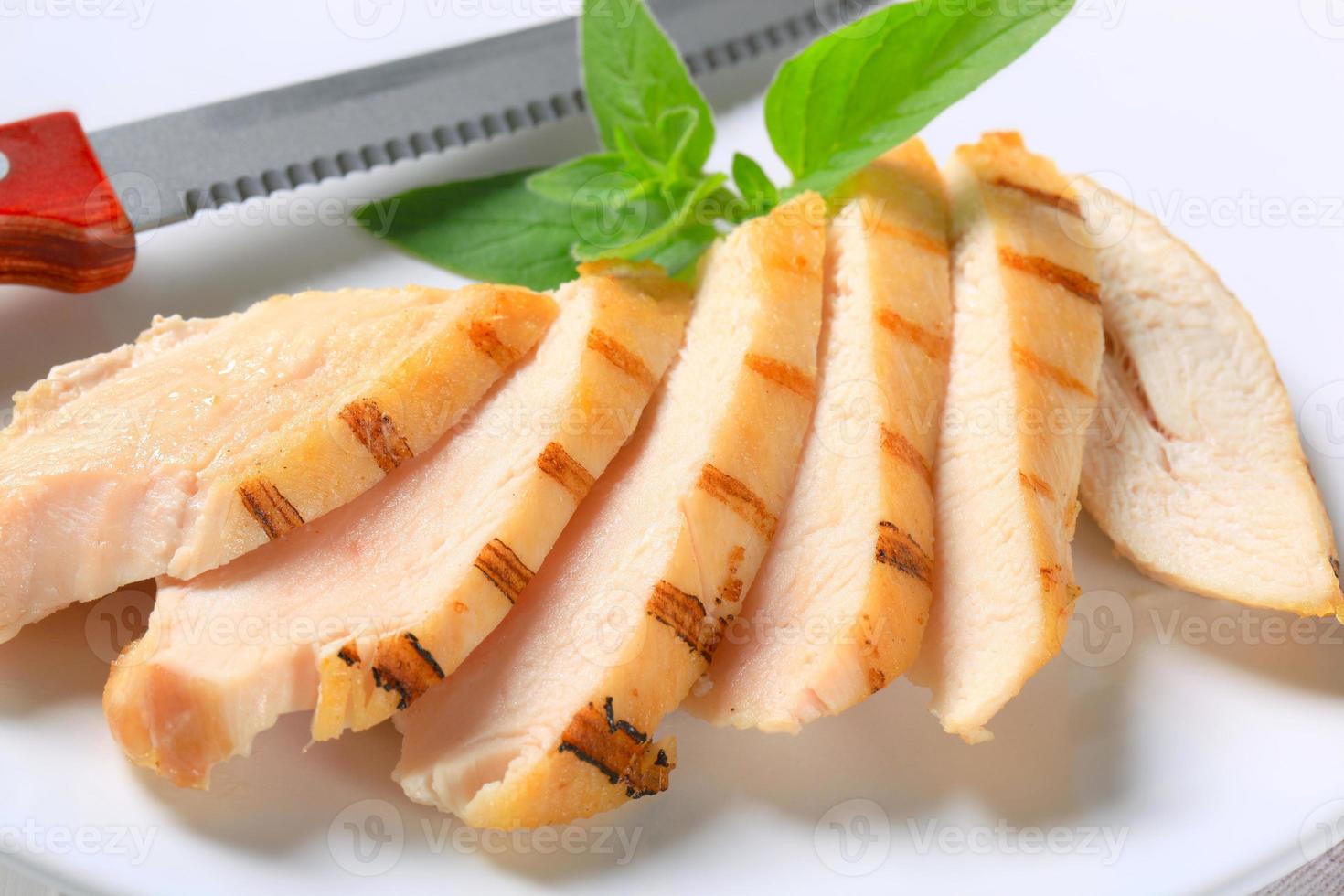 Slices of grilled chicken breast photo