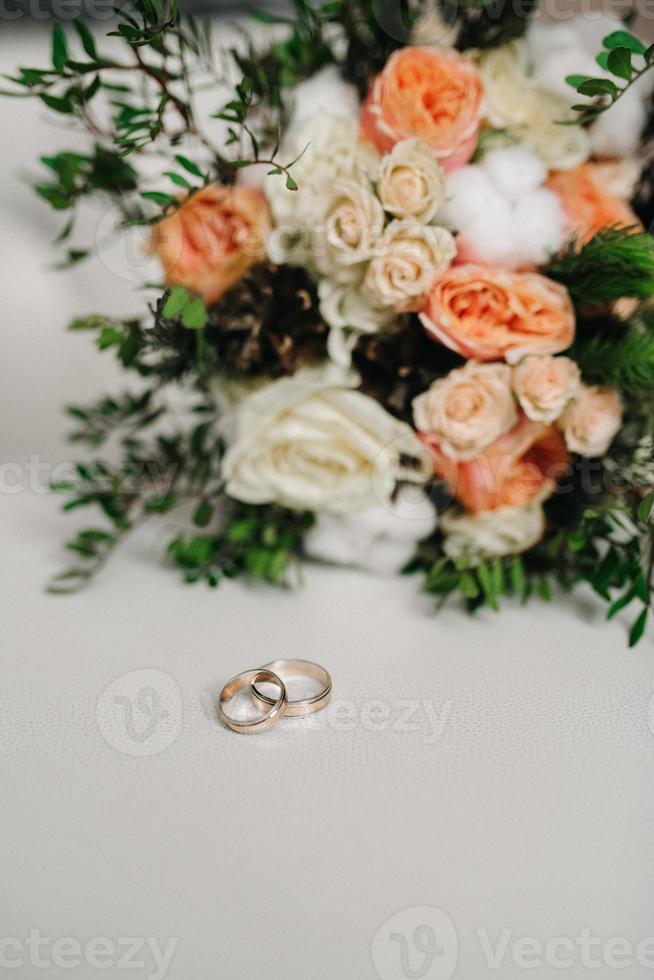 gold wedding rings as an attribute of a young couple's wedding photo