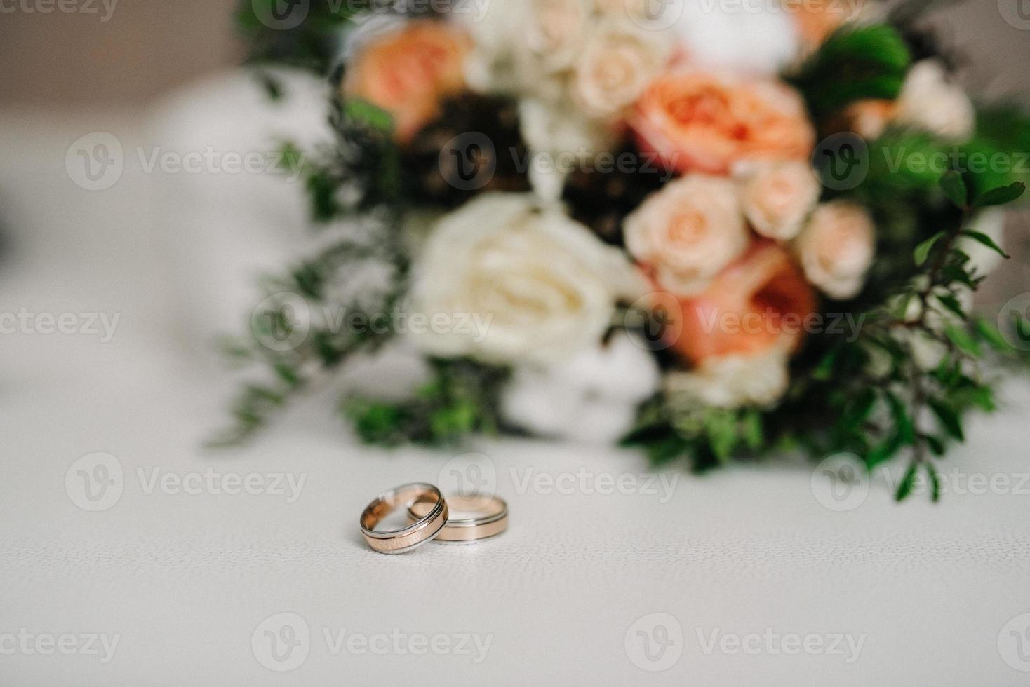 gold wedding rings as an attribute of a young couple's wedding photo