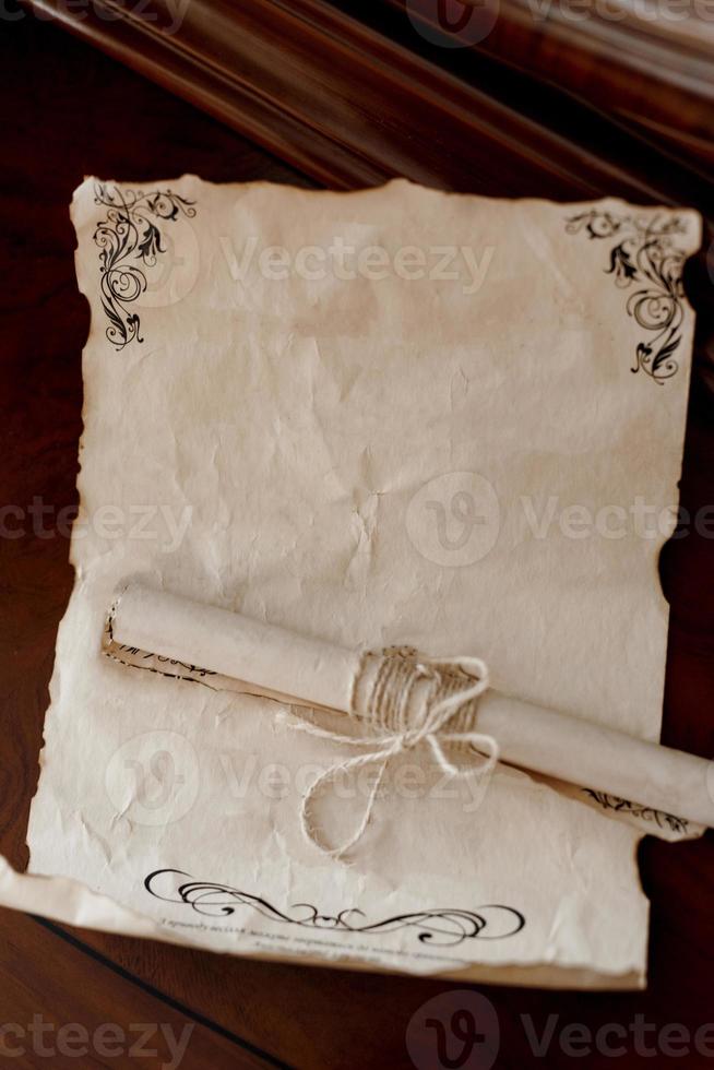 wedding invitation in a gray envelope on a table with green sprigs photo