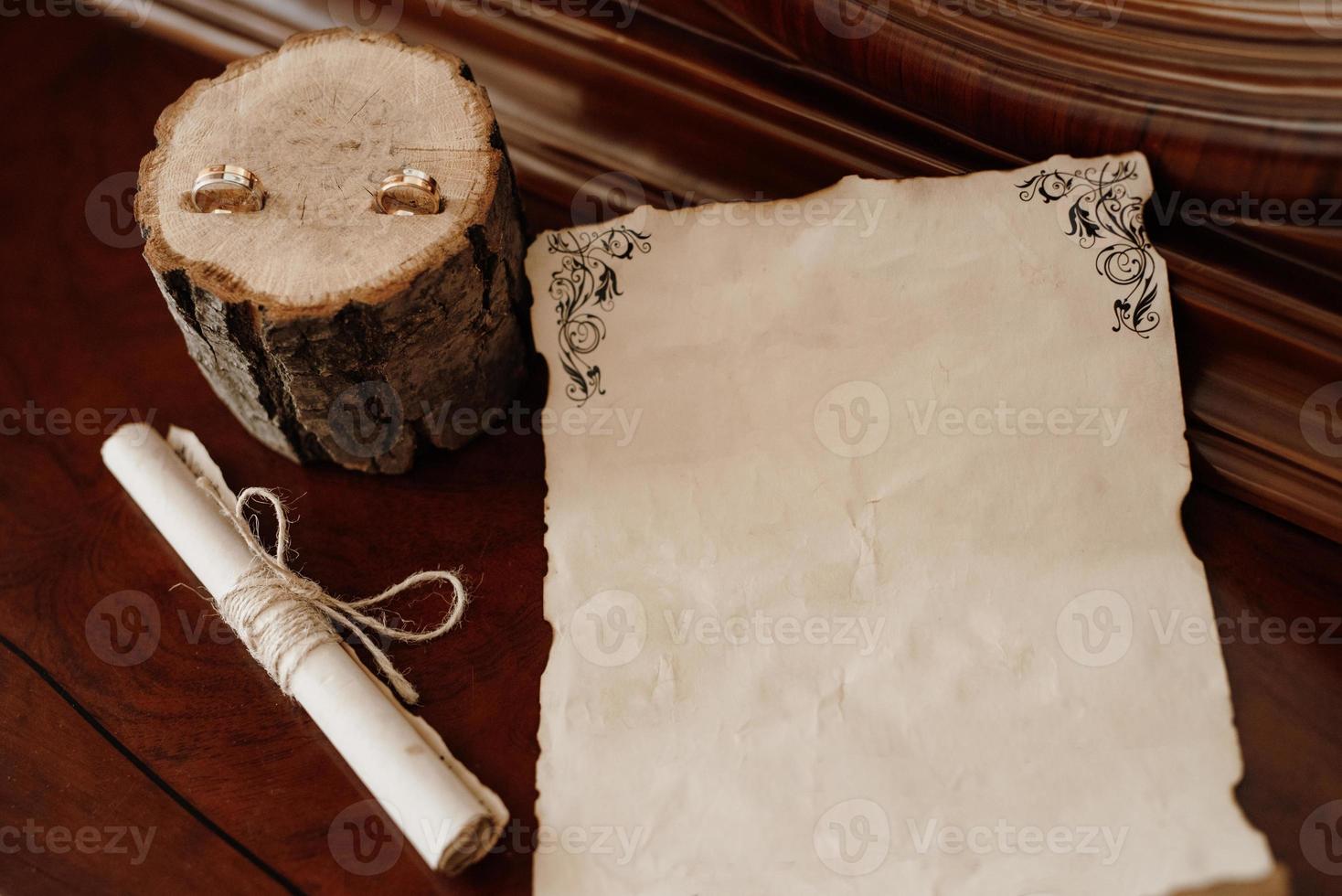 wedding invitation in a gray envelope on a table with green sprigs photo