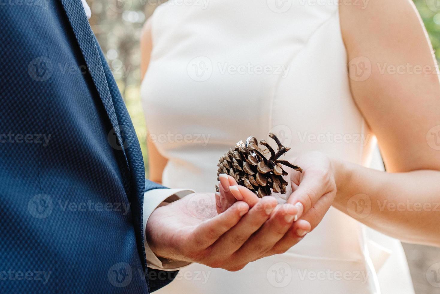 the bride and groom tenderly hold hands between them love and relationships photo