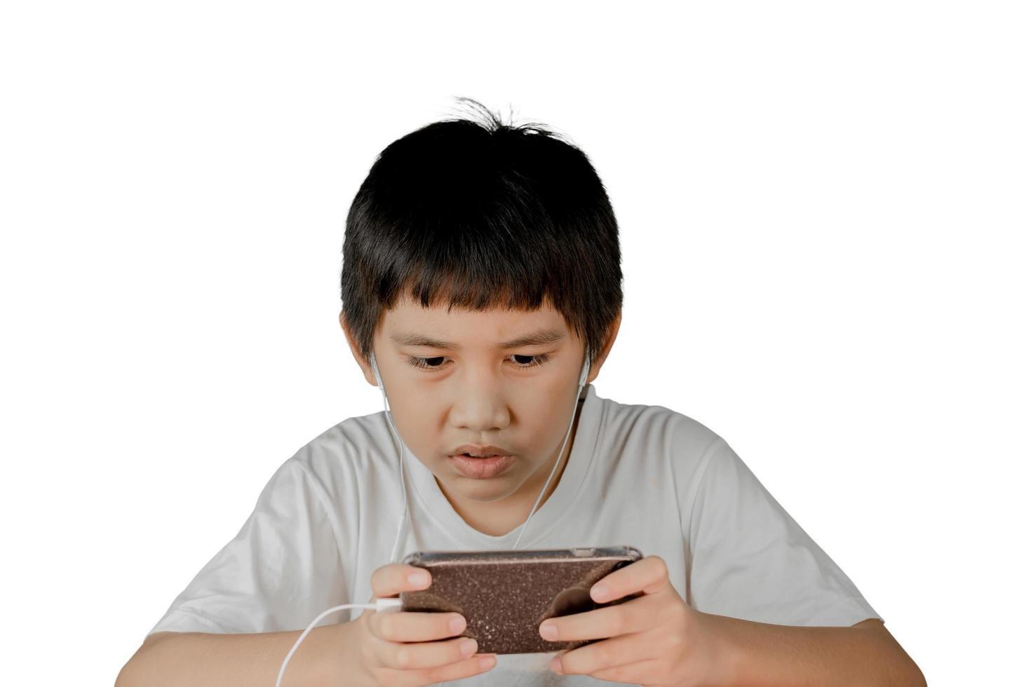 Asian boy wearing headphones playing a games on smart phone photo