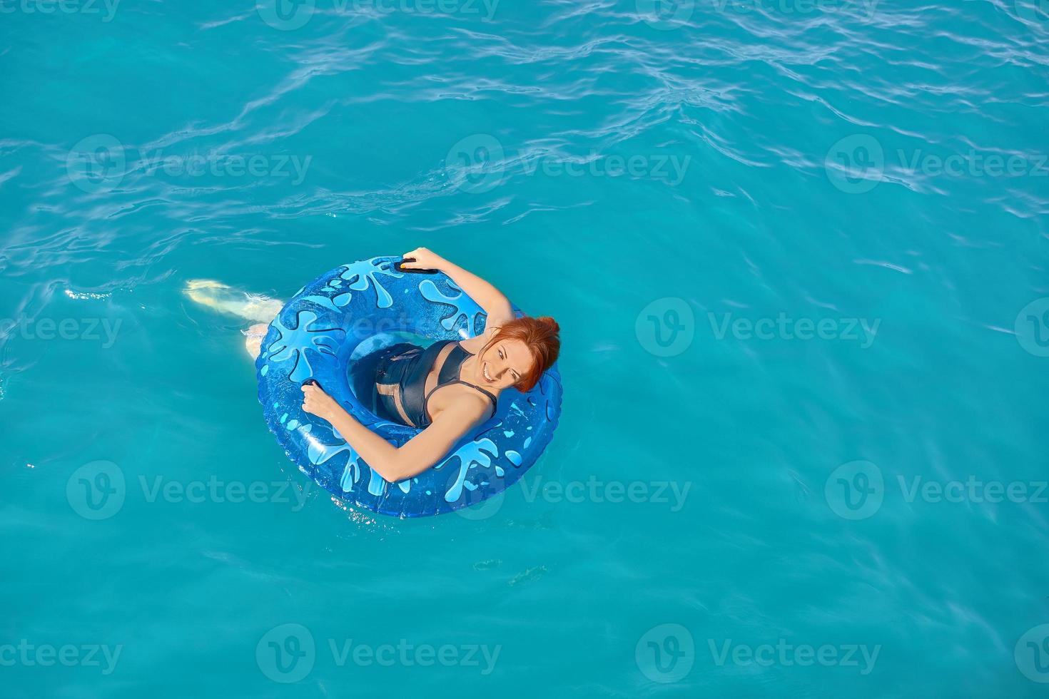 Woman relax on inflatable ring. photo