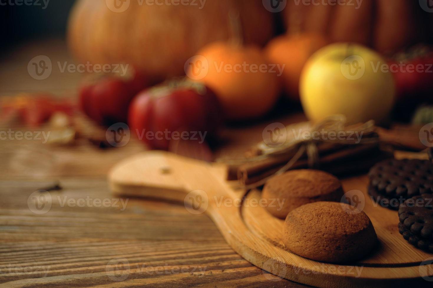 Cookies with pumpkins and apples on the table. photo