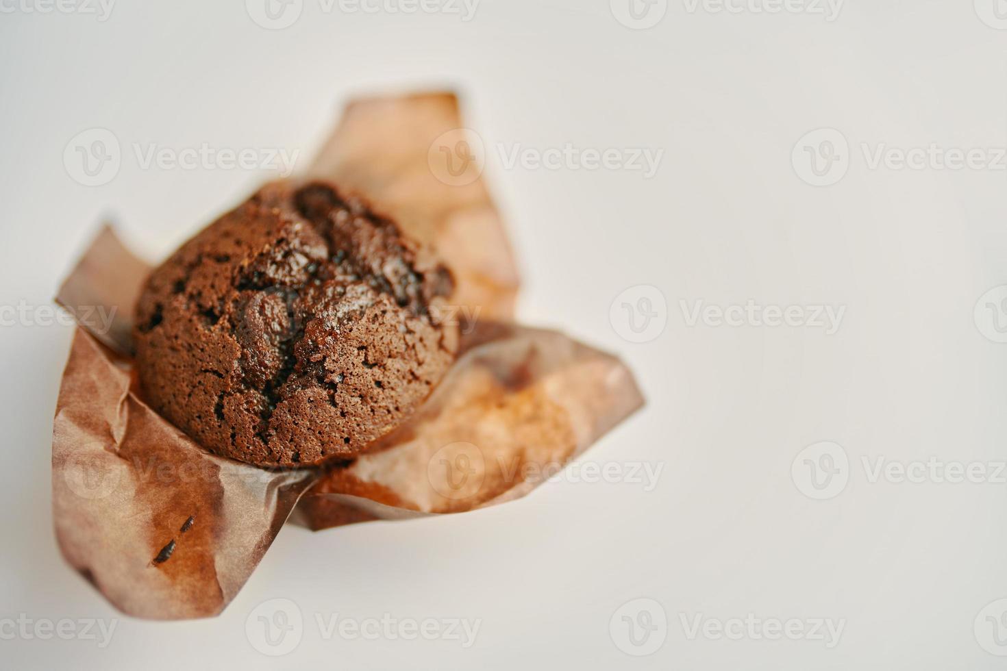 Cupcake with dark chocolate in paper wrapper. photo