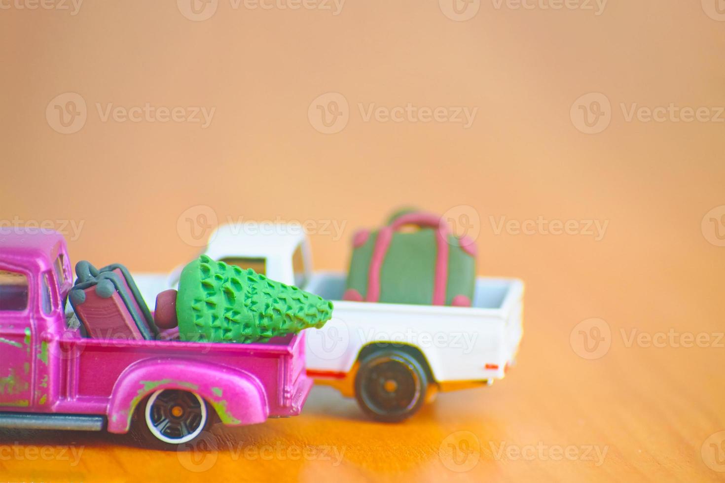 Car toy models with suitcases and christmas tree. photo