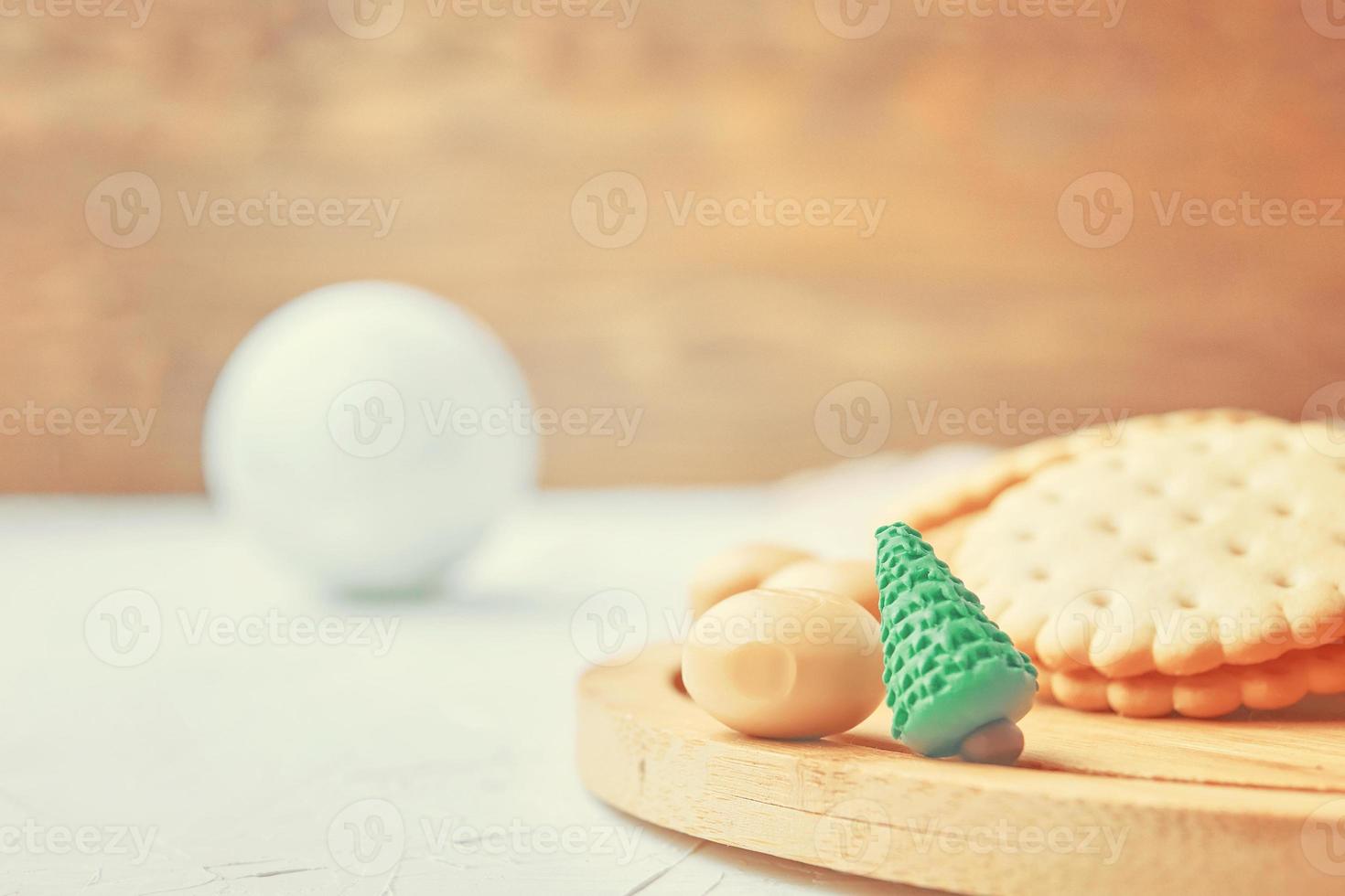 Cookies and candy on a wooden tray. photo