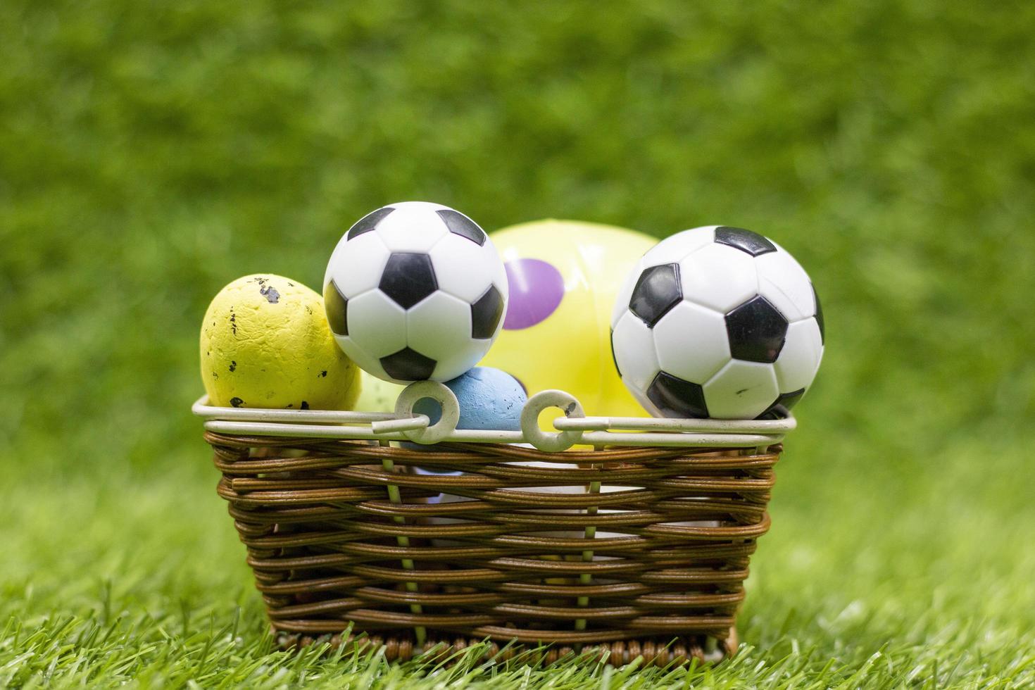 Soccer ball with Easter Holiday Decoration on green grass background photo