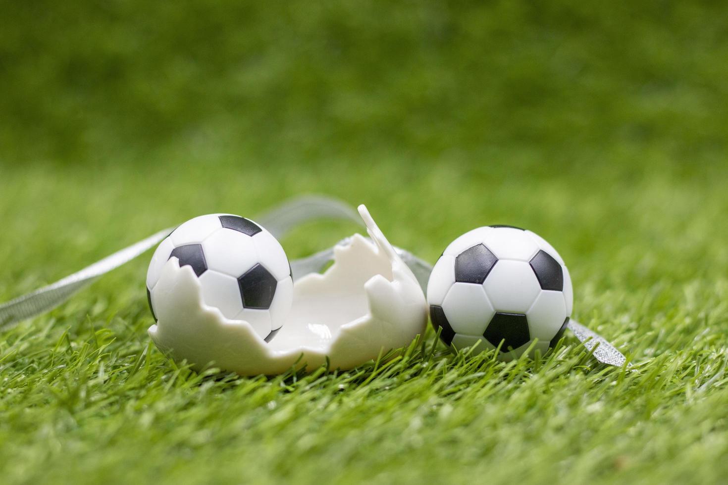 Soccer ball with Easter Holiday Decoration on green grass background photo