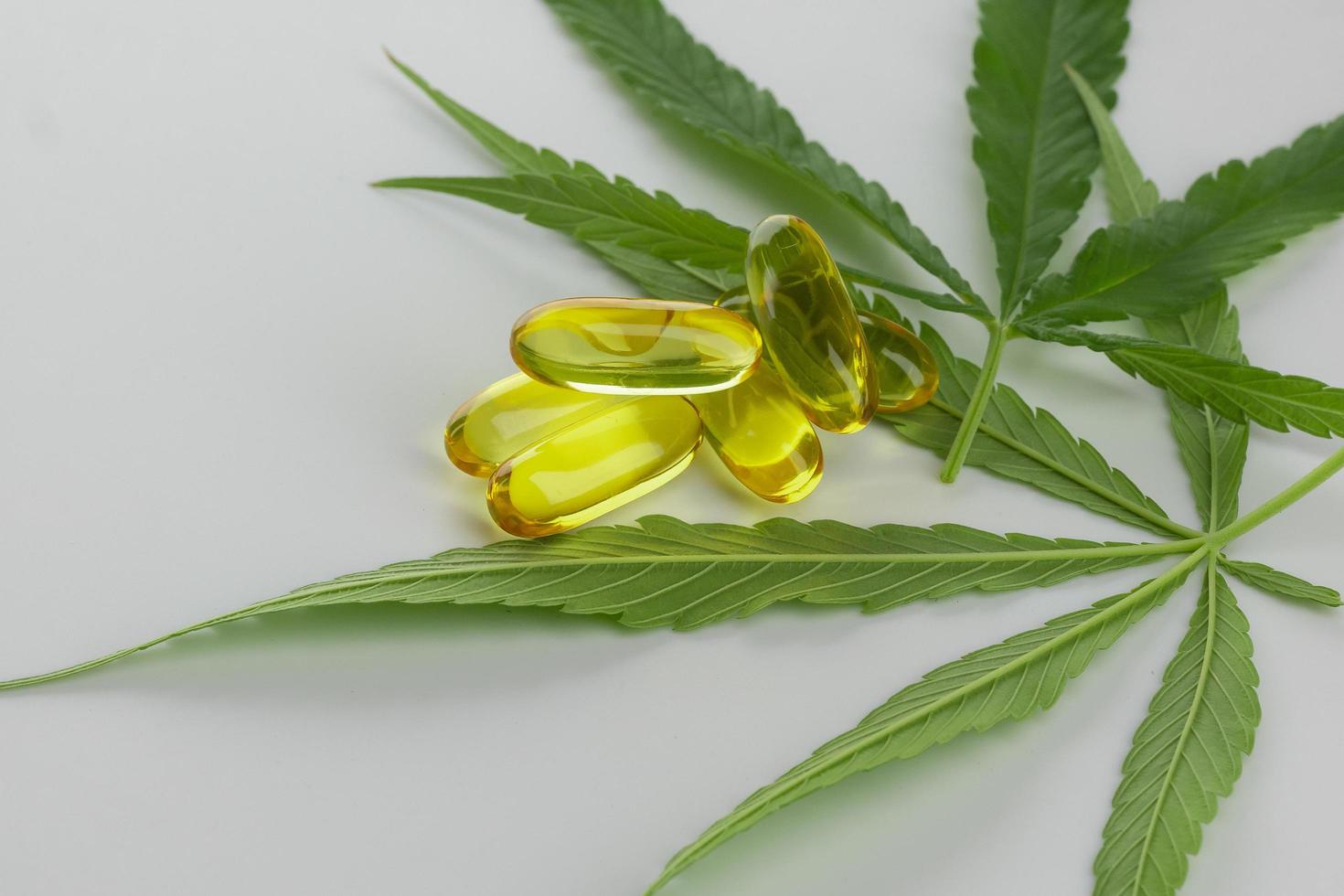 Cannabis essential oil Capsules on white background. photo