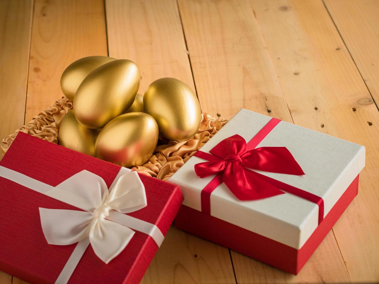 Financial success. Golden egg In a red gift box photo