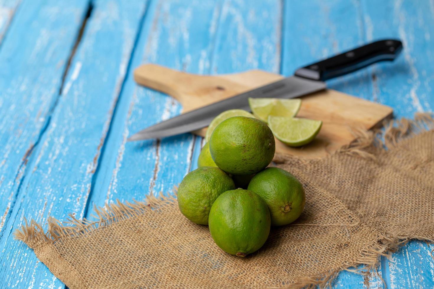 Lime juice and lemon on a blue wooden table photo