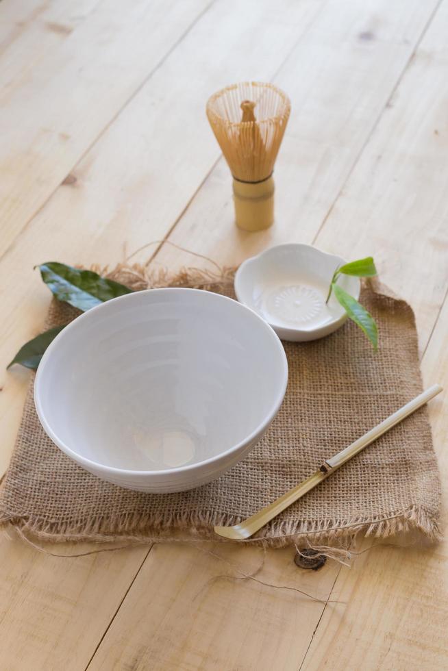 Set of matcha powder bowl, wooden spoon and whisk, green tea leaf, Organic Green Matcha Tea ceremony photo