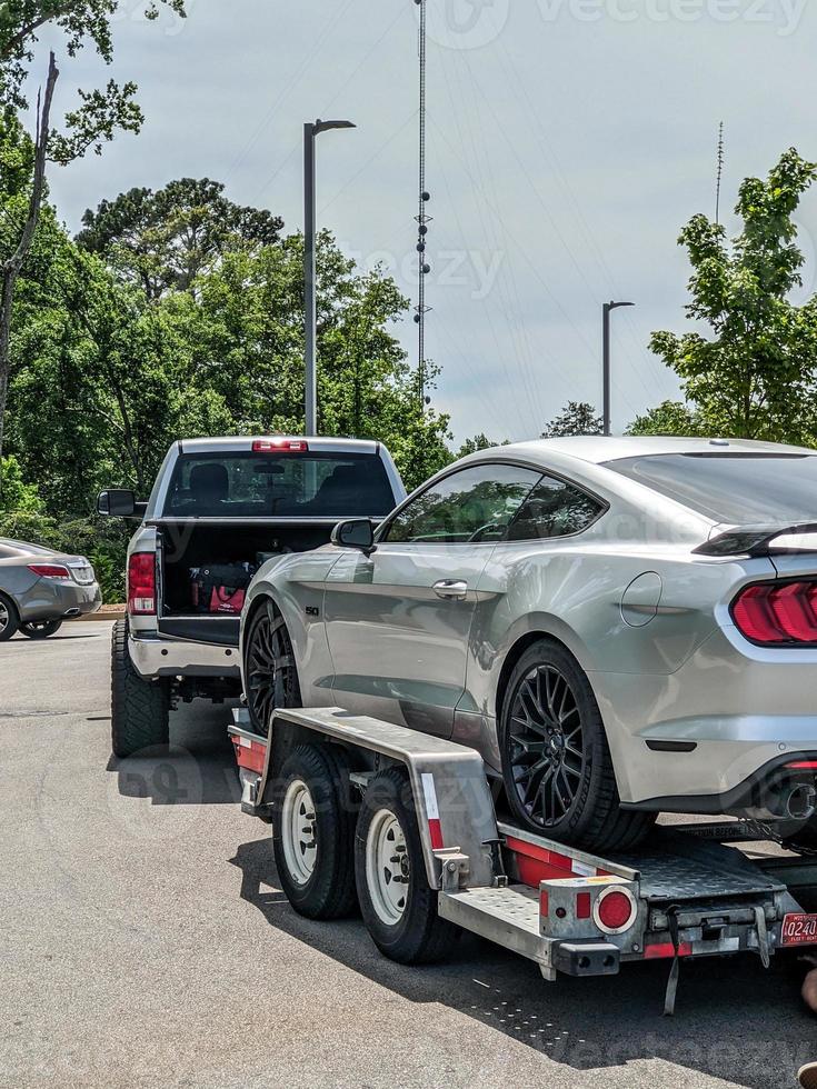 Loading broken car on a tow truck on a roadside photo