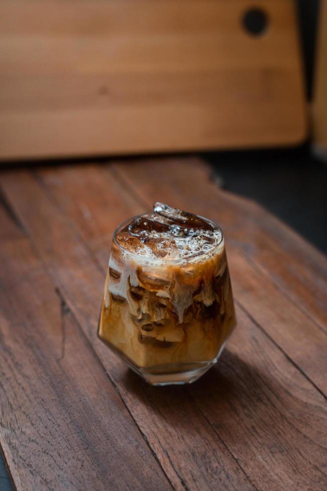 Glass of coffee with milk on the table photo