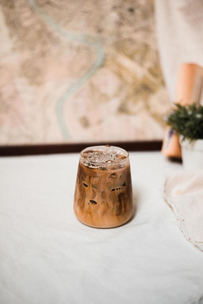 Glass of coffee with milk on the table photo