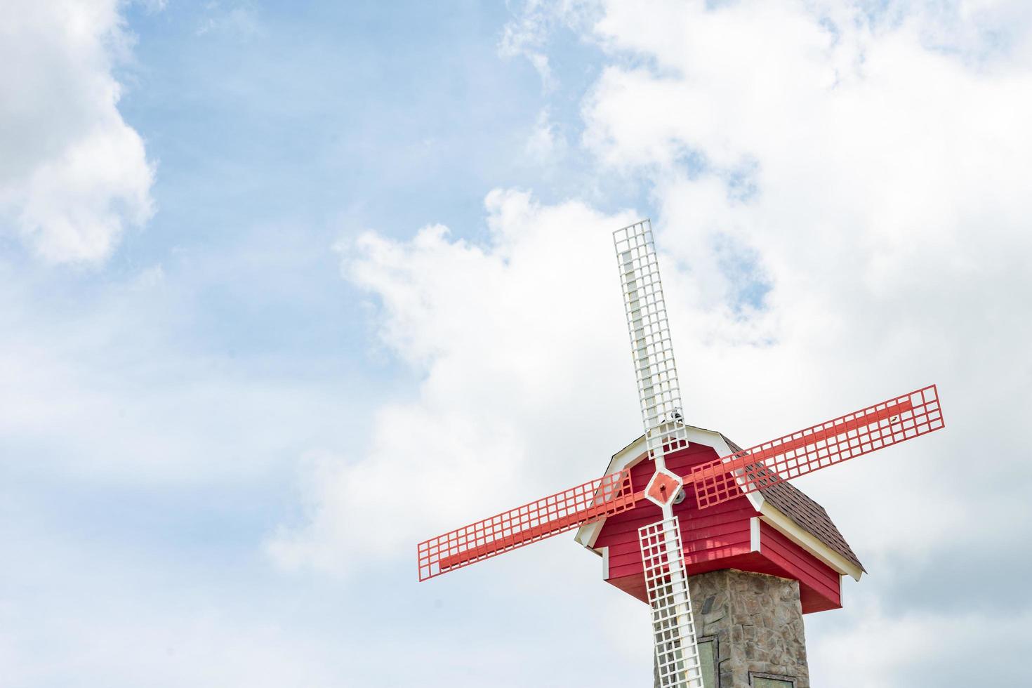 Dutch windmil on cloud and blue sky background. photo