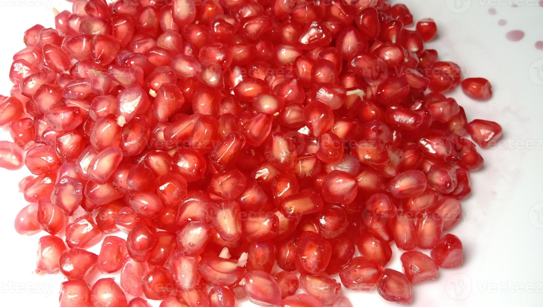 pomegranate seeds stock on plate photo