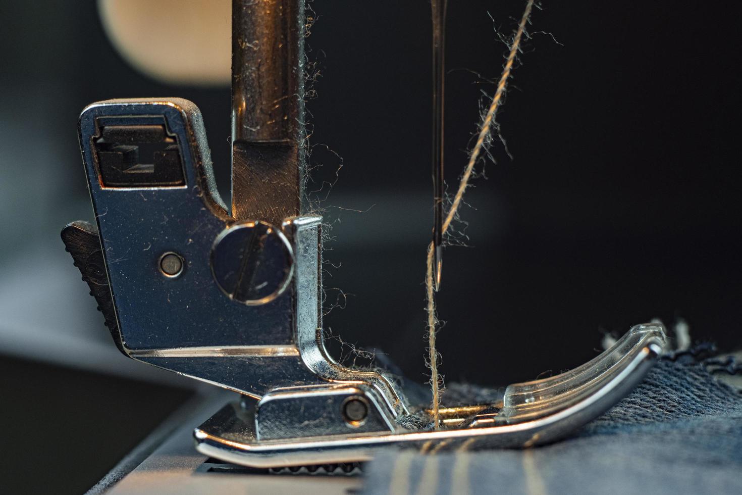 Close-up. A sewing machine sews Denim photo