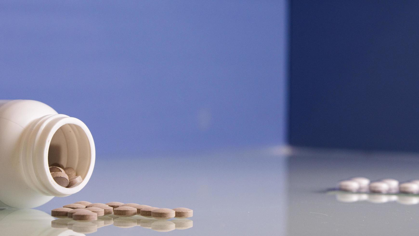 Pills Are Poured From A Bottle Of Pills. Medicine Concept photo