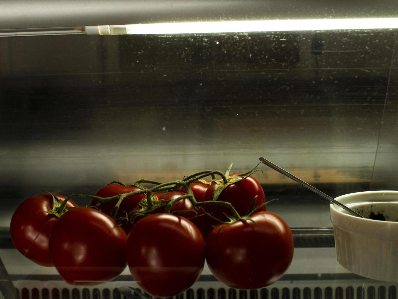 chili tomatoes on a branch in beautiful light on the wind photo