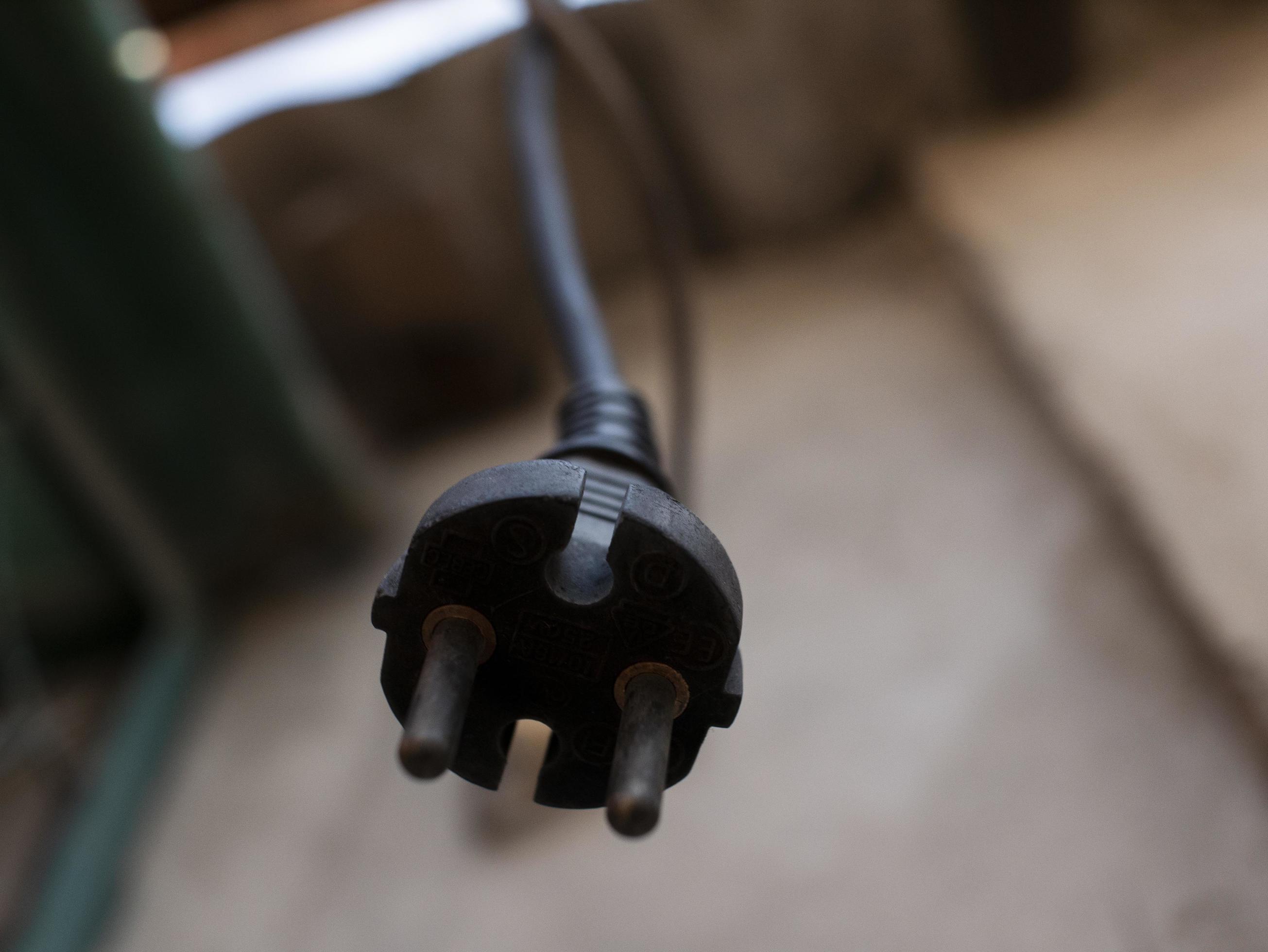 the plug from the socket hangs on the cord outdoor 2931613 Stock Photo