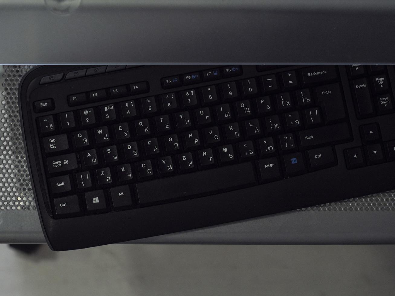 black computer keyboard on a metallic stand photo