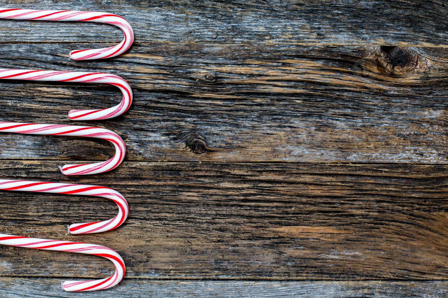 Rustic wood with candy canes background photo