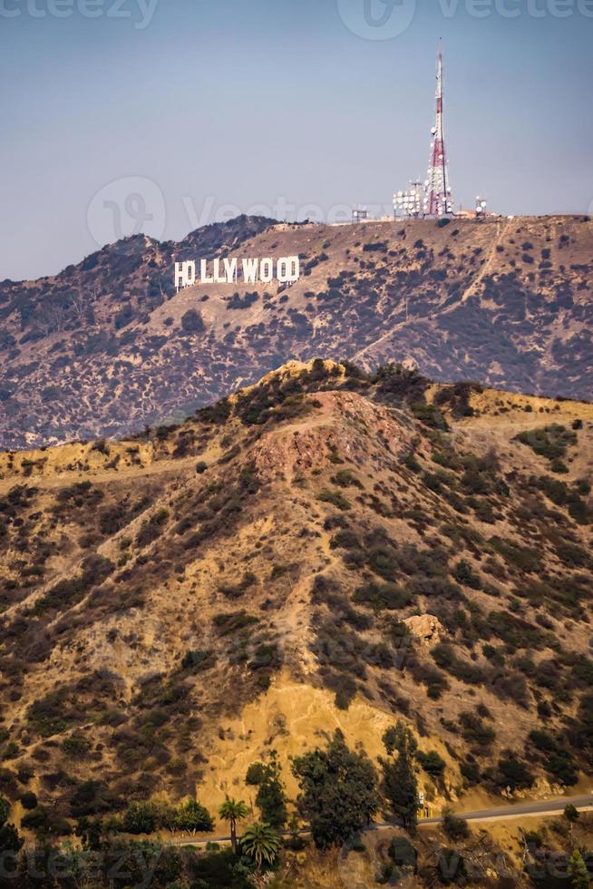 famous hollywood sign on a hill in a distance photo