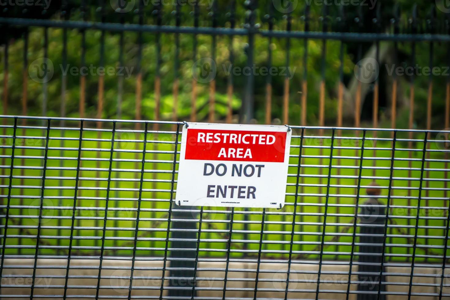 security fence border wall with do not enter sign photo