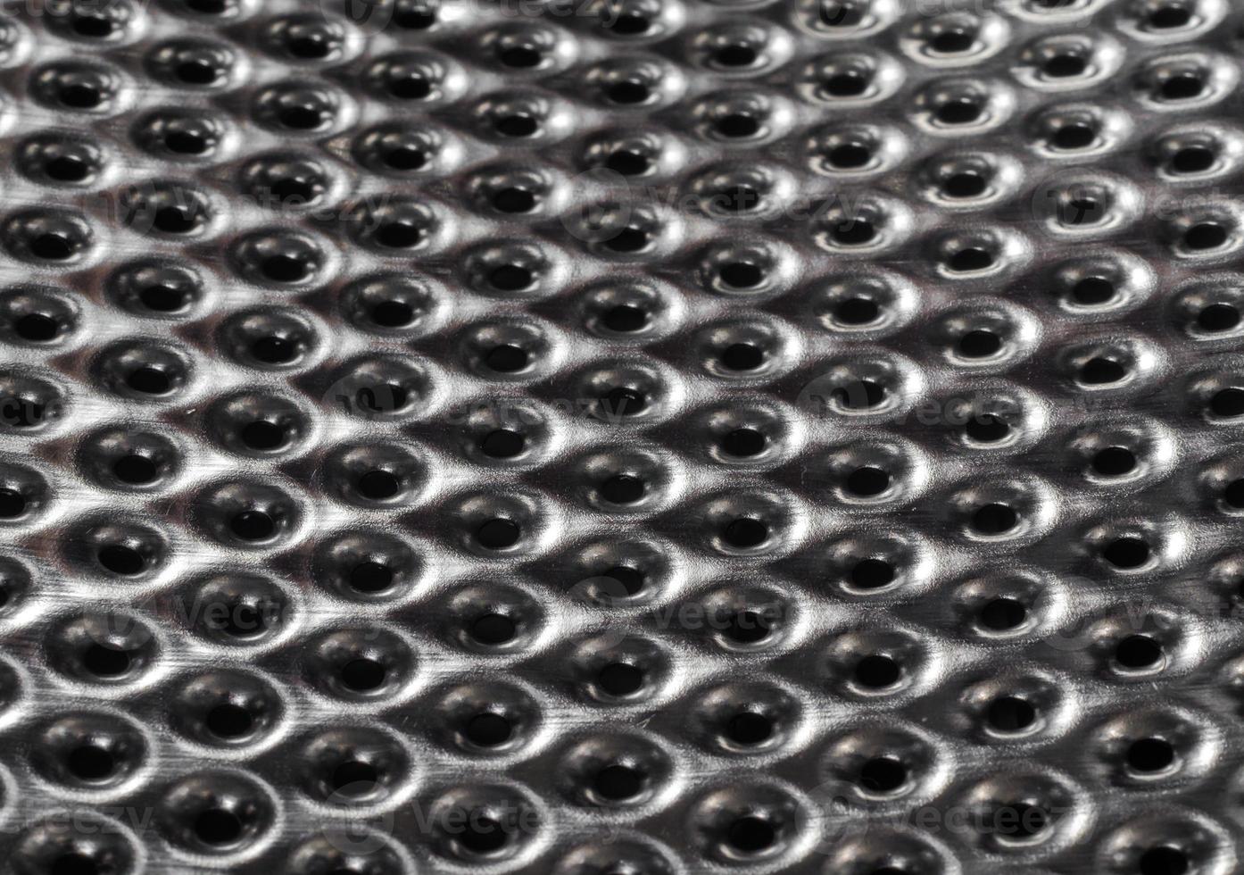 texture metal surface with a round perforation macro closeup photo