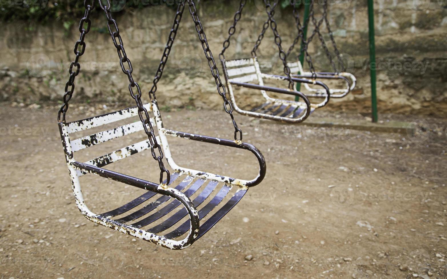 Old abandoned and rusty swings photo