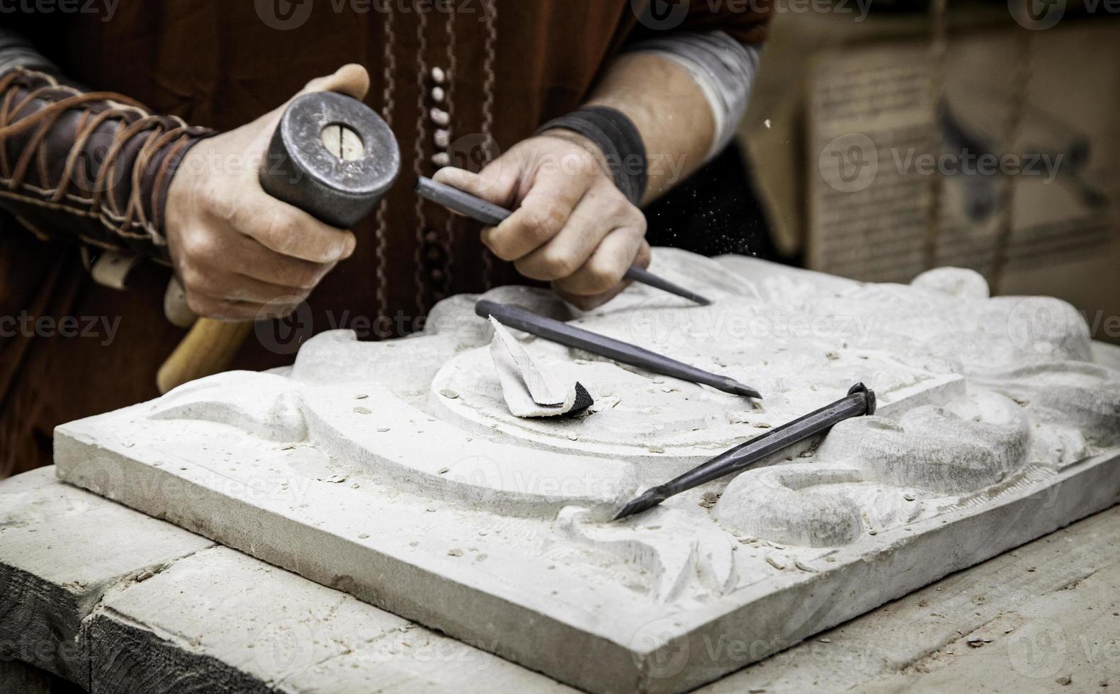 Carving stone in a traditional way photo