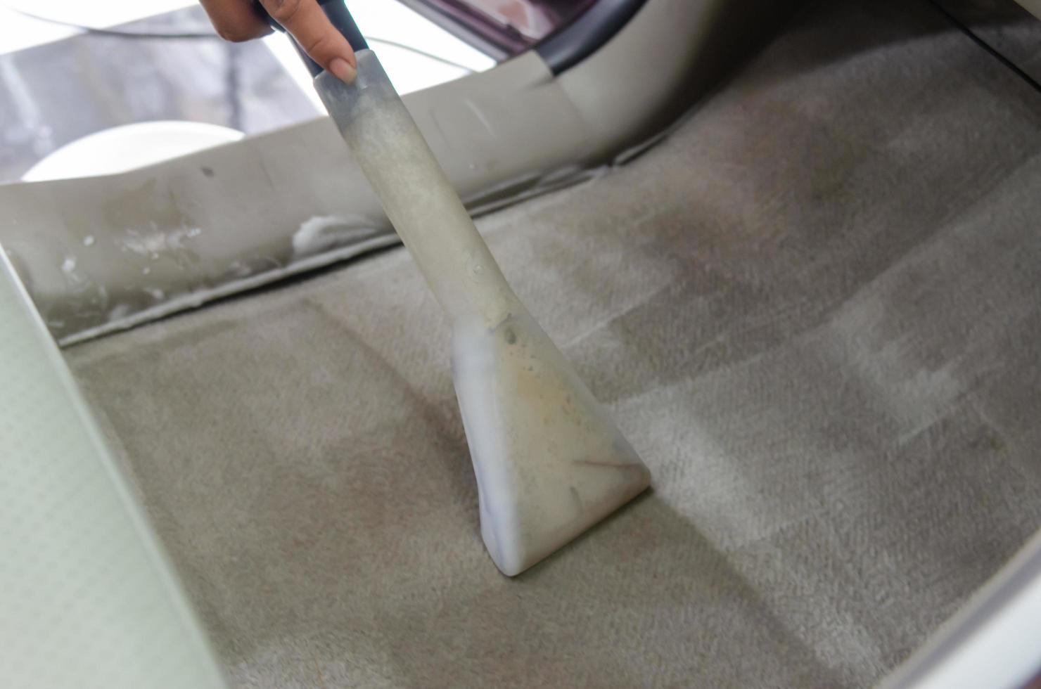 Suction disinfectant to clean the interior of the car cabin.Automotive carpet wet cleaning tools.Wash the car carpet photo