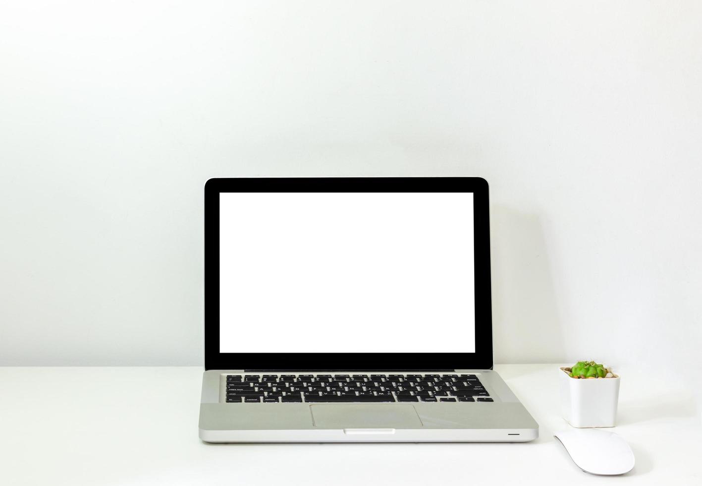 Computer laptop mock up and mouse Cactus white blank screen on table. Used to advertise text on the computer screen photo