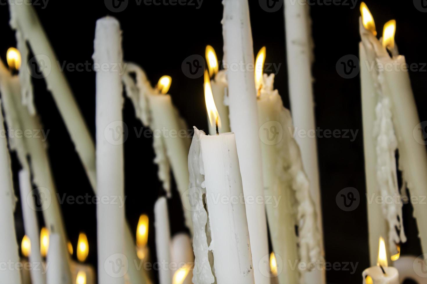 Wax candles lit with fire photo
