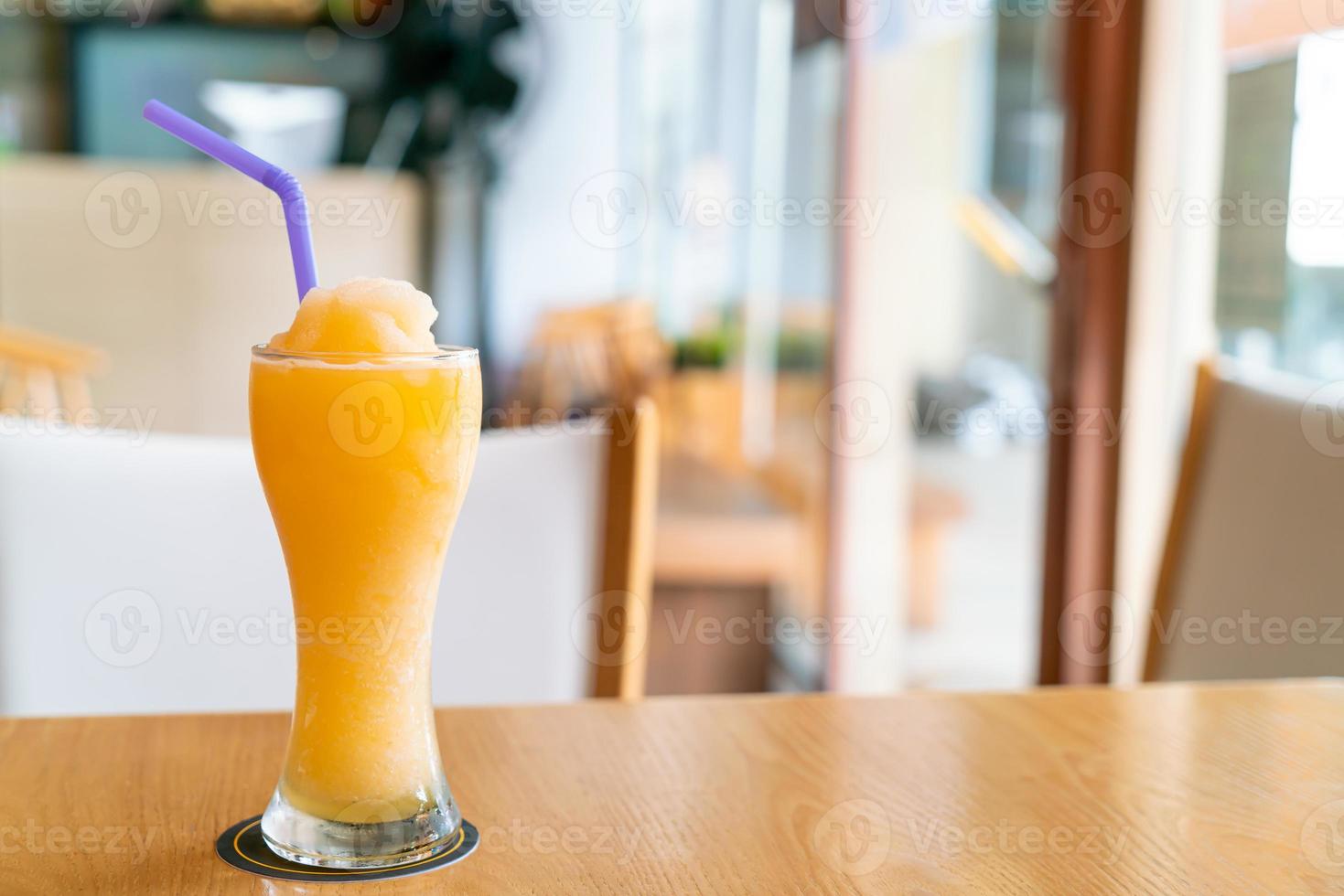 Orange juice blend smoothie glass in cafe restaurant photo